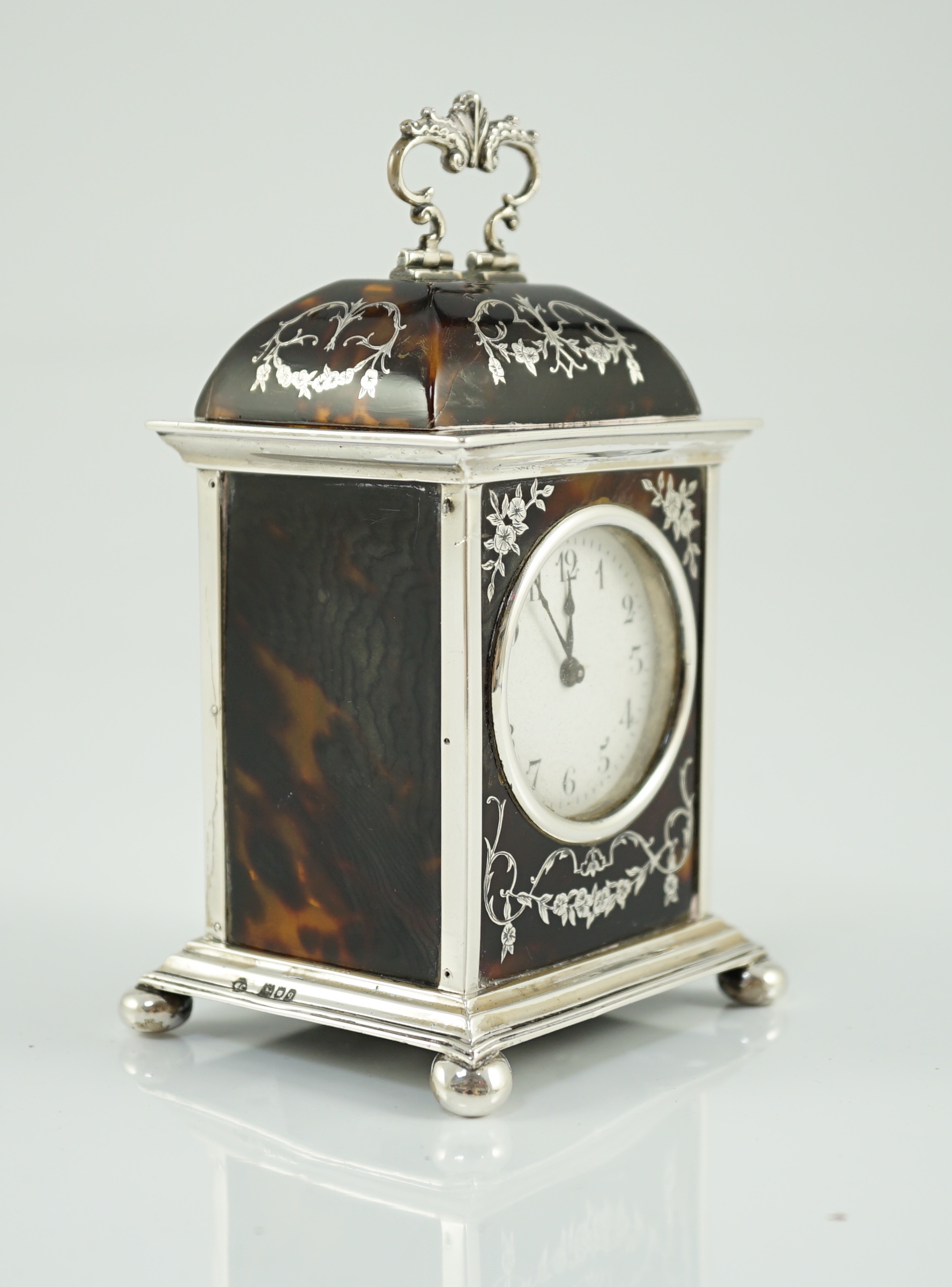 A George V silver and tortoiseshell pique mounted carriage timepiece, by William Comyns